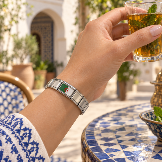 Algeria flag Italian charm on a polished silver charm bracelet in a sunlit courtyard café