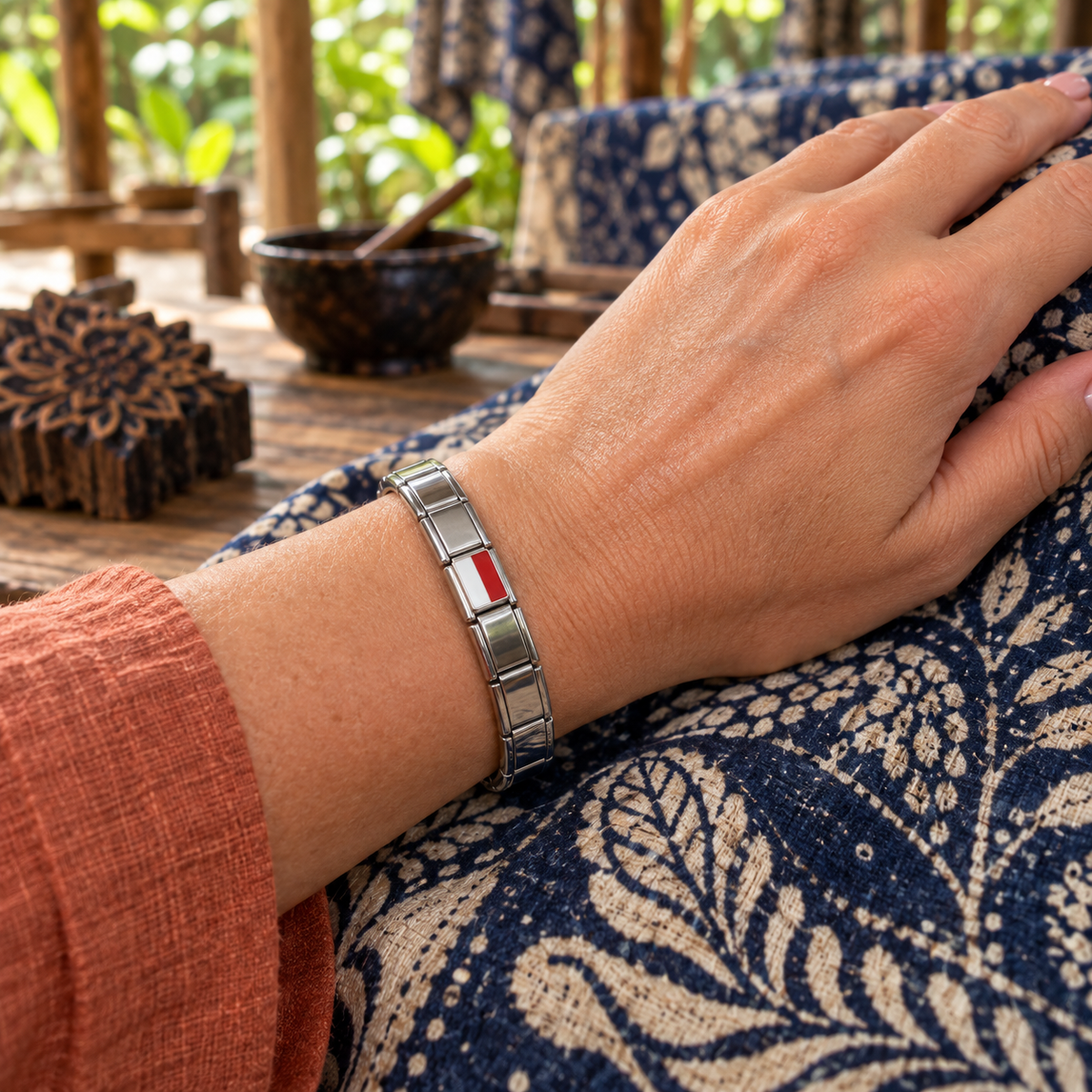 Indonesia flag Italian charm on a silver base modular bracelet in a traditional batik workshop