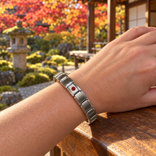 Japan flag Italian charm on a polished silver modular bracelet worn in a Kyoto garden with autumn maple leaves