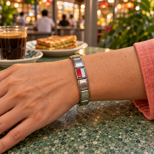 Singapore flag Italian charm on an Italian charm bracelet worn at a lively hawker centre with kopi and kaya toast