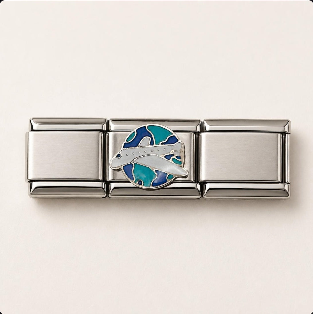 Airplane & Globe Italian Charm on a bracelet, flat lay