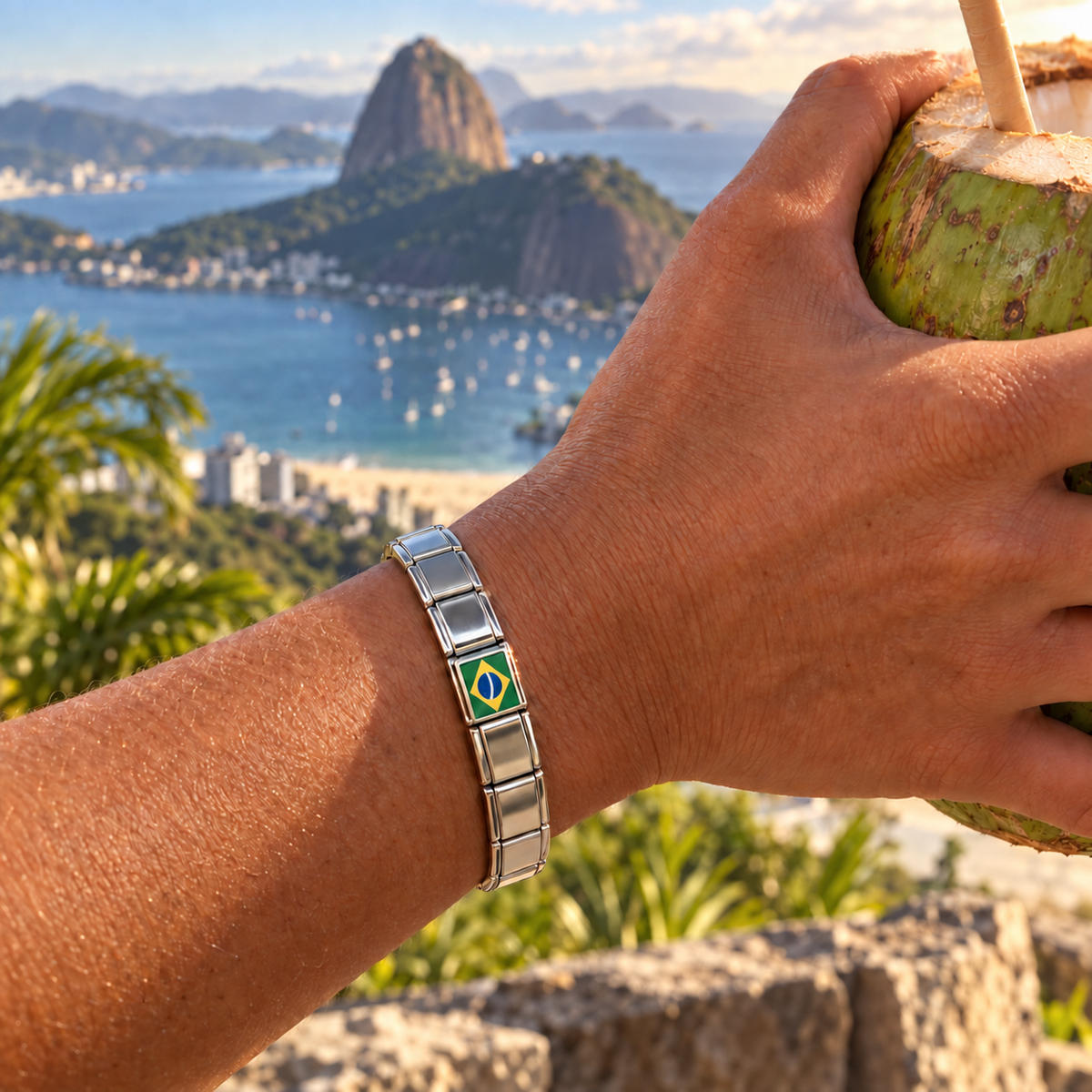 Brazil flag Italian charm on a polished silver bracelet overlooking Sugarloaf Mountain in Rio de Janeiro
