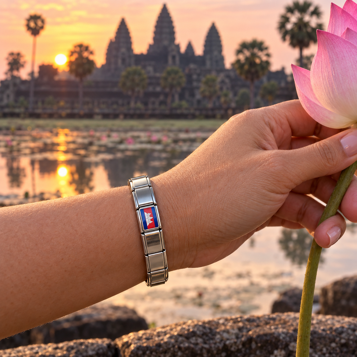 Cambodia flag Italian charm on a polished silver bracelet at Angkor Wat during sunrise
