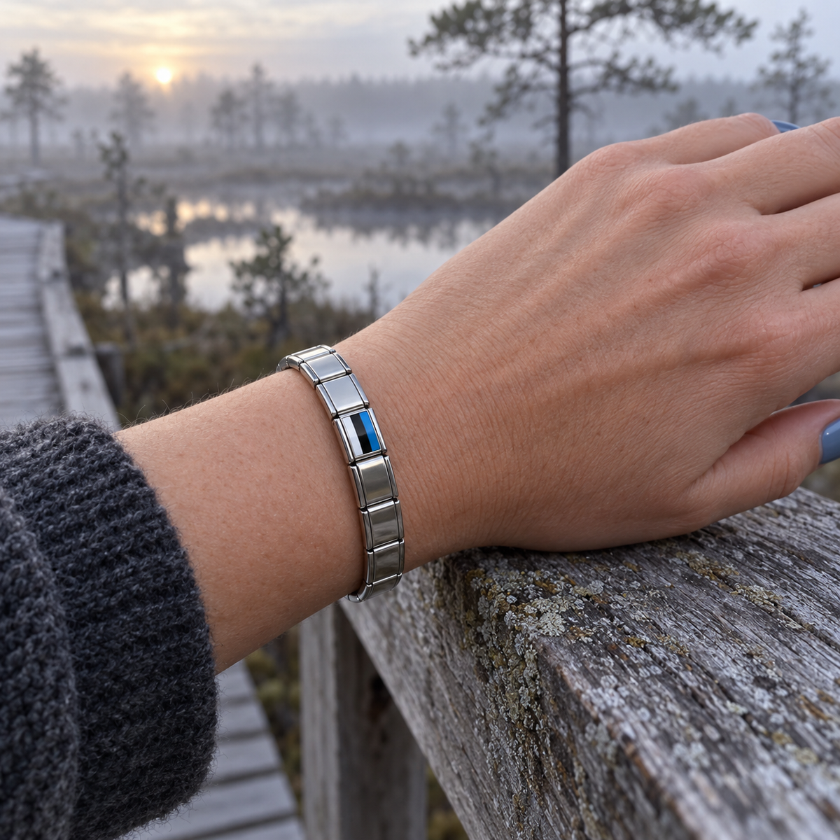 Estonia flag Italian charm on a polished silver Italian charm base bracelet overlooking a misty Baltic bog boardwalk
