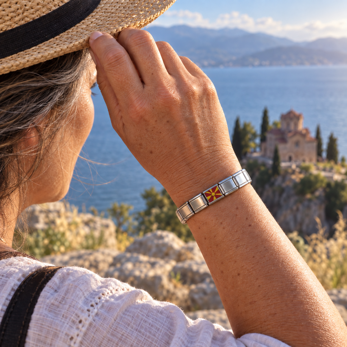 North Macedonia flag Italian charm on a silver starter bracelet overlooking Lake Ohrid and St. John at Kaneo