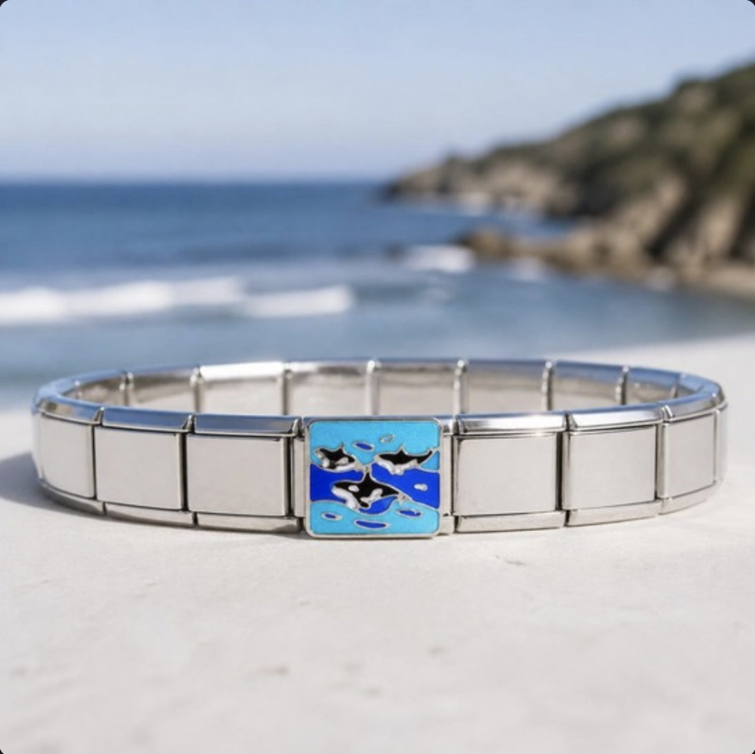 Orcas Italian charm on bracelet, flat lay