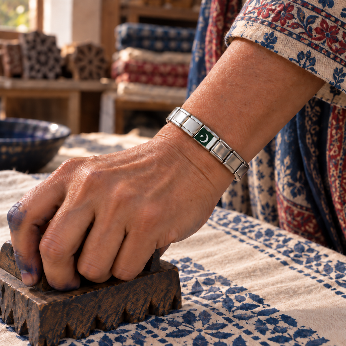 Pakistan flag Italian charm on a polished  bracelet worn by a textile artisan creating traditional block-printed fabric