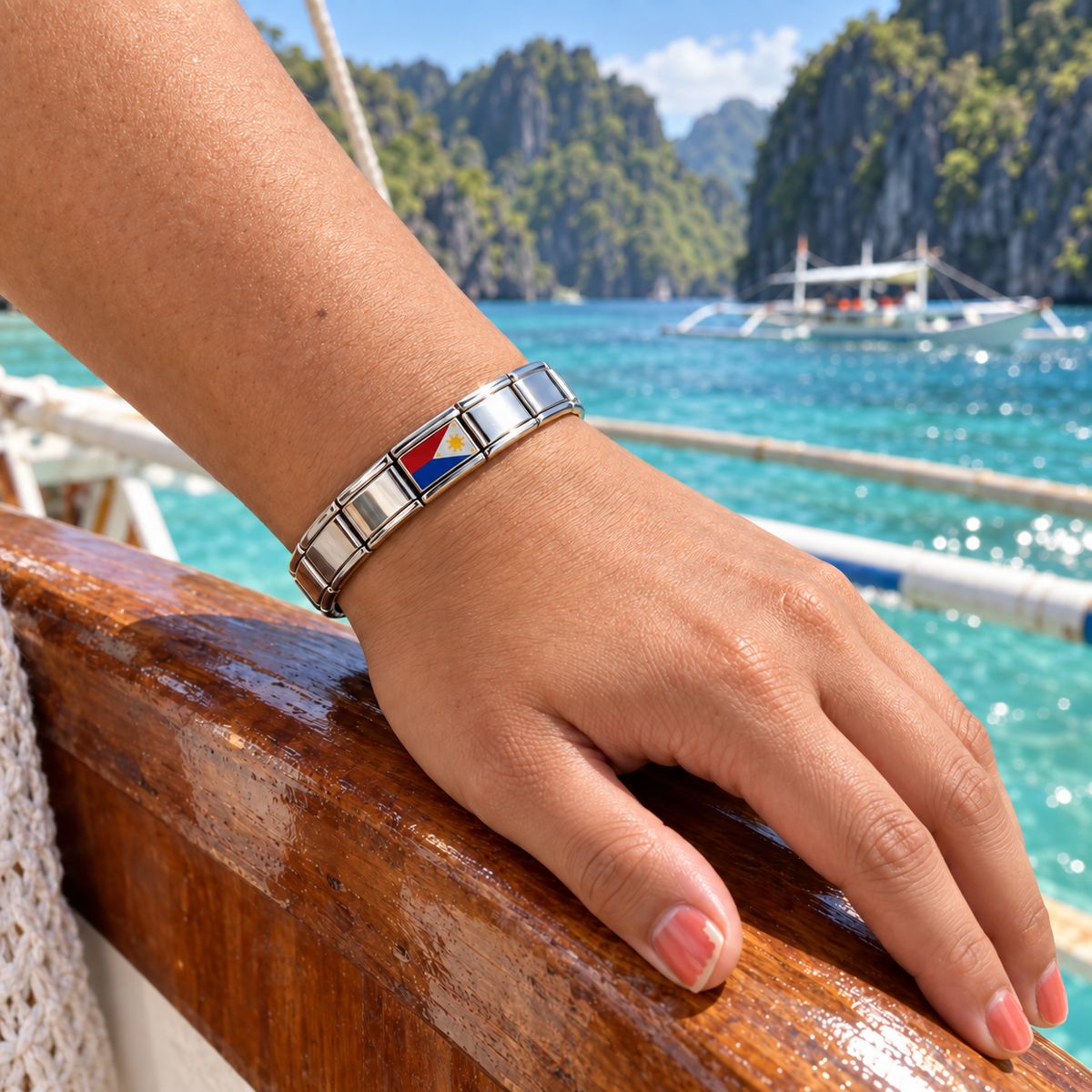 Philippines flag Italian charm on a silver Italian charm bracelet worn by a traveler aboard an outrigger boat in Palawan