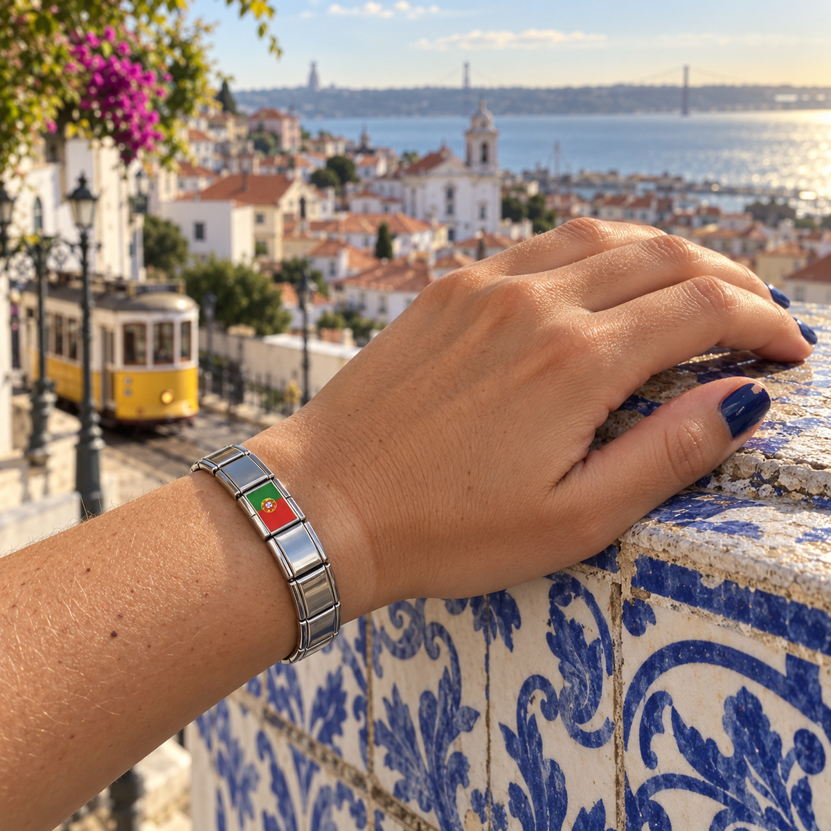 Portugal flag Italian charm on a polished silver charm bracelet worn at a Lisbon overlook with azulejo tiles and a yellow tram
