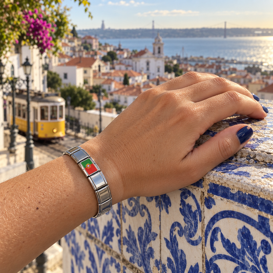 Portugal flag Italian charm on a polished silver charm bracelet worn at a Lisbon overlook with azulejo tiles and a yellow tram
